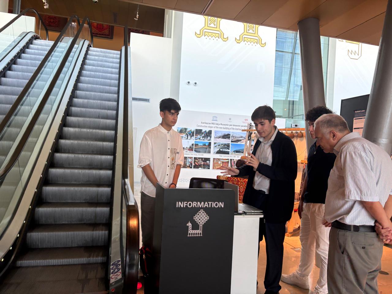 Team members demonstrating the ReHand Loom prototype to the local specialist engineer at the Azerbaijan National Carpet Museum